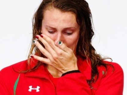 GLASGOW, SCOTLAND - JULY 28:  Gold medallist Jazz Carlin of Wales gets emotional during the medal ceremony for the Women's 800m Freestyle Final at Tollcross International Swimming Centre during day five of the Glasgow 2014 Commonwealth Games on July 28, 2014 in Glasgow, Scotland.  (Photo by Clive Rose/Getty Images)